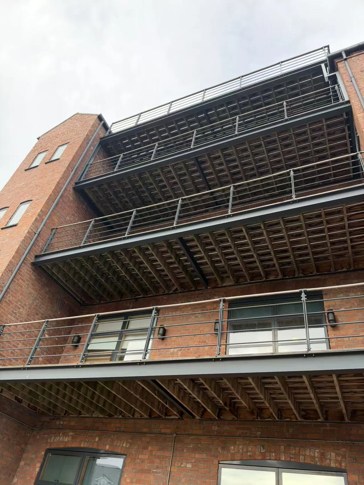 Real exterior of Lugano House, showing its brick facade and balconies